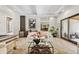 Beautiful living room with a wet bar, modern decor, and access to outdoor space, ideal for entertaining at 6115 Stonegate Run, Zionsville, IN 46077