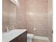 Charming powder room features patterned wallpaper, a modern sink and faucet, and a matching mirror at 6115 Stonegate Run, Zionsville, IN 46077