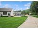 Extensive property featuring a modern home, detached garage and playhouse, surrounded by a lush green lawn at 6115 Stonegate Run, Zionsville, IN 46077
