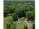Expansive aerial view of home on a large lot with a pond, above-ground pool and two-car garage at 6295 State Road 142 Rd, Martinsville, IN 46151
