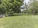 Large backyard featuring a pond and mature trees at 6295 State Road 142 Rd, Martinsville, IN 46151