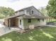 Charming two-story home with gray and beige exterior, lush landscaping, and a inviting covered porch at 6295 State Road 142 Rd, Martinsville, IN 46151