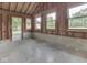 Unfinished garage featuring bare wood walls, concrete flooring, and large windows providing ample natural light at 6295 State Road 142 Rd, Martinsville, IN 46151
