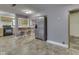 Bright kitchen with stainless steel appliances, breakfast bar, and views into the adjacent room at 6295 State Road 142 Rd, Martinsville, IN 46151
