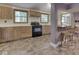 Well-lit kitchen with wood cabinets, black gas range and oven, and tile flooring at 6295 State Road 142 Rd, Martinsville, IN 46151