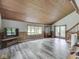 Spacious living room featuring wood paneled vaulted ceilings, neutral walls, and new flooring at 6295 State Road 142 Rd, Martinsville, IN 46151