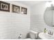 Bright bathroom features modern subway tile, sleek fixtures, and framed artwork for a stylish and clean aesthetic at 6580 Halsey St, Zionsville, IN 46077