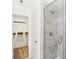 A modern bathroom with white marble shower and a view to walk-in closet at 6580 Halsey St, Zionsville, IN 46077