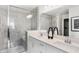 Bright bathroom featuring double vanity, large mirror, and a spacious glass-enclosed shower with marble-style tiles at 6580 Halsey St, Zionsville, IN 46077