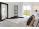 Bright bedroom showcases a large window, modern artwork, and coordinated bedding at 6580 Halsey St, Zionsville, IN 46077