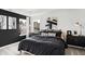 Modern bedroom with two windows, a black accent wall, and contemporary decor at 6580 Halsey St, Zionsville, IN 46077