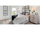 Inviting bedroom with a shiplap accent wall, decorative pillows, and soft, natural light at 6580 Halsey St, Zionsville, IN 46077