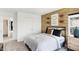 Comfortable bedroom featuring a wood-accent wall, modern décor, and plenty of natural light at 6580 Halsey St, Zionsville, IN 46077