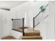 Bright entryway featuring hardwood floors, white walls, and a staircase with modern railing leading to the upper level at 6580 Halsey St, Zionsville, IN 46077