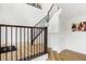 Spacious entryway with hardwood floors, a staircase with dark railing, and white walls for a modern feel at 6580 Halsey St, Zionsville, IN 46077