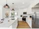 Modern kitchen with stainless appliances, gas range, white cabinets, and an island with breakfast bar at 6580 Halsey St, Zionsville, IN 46077