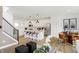 Open concept living space featuring a kitchen with a large island and a dining room with stylish decor at 6580 Halsey St, Zionsville, IN 46077