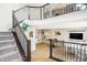 Open-concept living space with hardwood floors, a staircase, and ample natural light at 6580 Halsey St, Zionsville, IN 46077