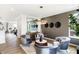 Stylish sitting room features hardwood floors, a designer accent wall, modern furniture, and ample natural light at 6580 Halsey St, Zionsville, IN 46077