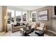 Bright living room showcases neutral tones, modern decor, comfortable seating, and large windows with neighborhood views at 6580 Halsey St, Zionsville, IN 46077