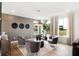 Elegant living room showcases a textured accent wall, modern lighting, hardwood floors, and comfortable seating at 6580 Halsey St, Zionsville, IN 46077