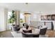 Elegant living area boasts modern decor, stylish chairs, large windows, and a neutral color palette at 6580 Halsey St, Zionsville, IN 46077