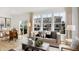Comfortable living room featuring a cozy sofa, stylish decor, large windows, and modern furnishings with hardwood floors at 6580 Halsey St, Zionsville, IN 46077