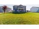 Spacious backyard featuring a well-maintained lawn, covered patio with sliding glass door and traditional two-story home at 6610 Aberdeen Dr, McCordsville, IN 46055