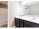 Bathroom featuring a double sink vanity with dark cabinets and bright lighting at 6610 Aberdeen Dr, McCordsville, IN 46055