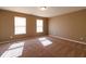 Neutral-colored bedroom featuring plush carpeting, a ceiling light fixture, and natural light from windows at 6610 Aberdeen Dr, McCordsville, IN 46055