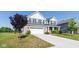 View of home showing brick, white garage door, landscaping, blue vinyl siding, and front yard at 6610 Aberdeen Dr, McCordsville, IN 46055