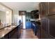 Close up of a modern kitchen with stainless steel appliances, dark cabinets, and stylish granite countertops at 6610 Aberdeen Dr, McCordsville, IN 46055
