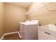 Well-maintained laundry room includes a washer, dryer, utility sink, and storage shelf at 6610 Aberdeen Dr, McCordsville, IN 46055