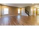 Spacious living room with hardwood flooring, staircase, and large windows at 6610 Aberdeen Dr, McCordsville, IN 46055