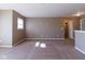 Large carpeted loft area offering flexible space with natural light and access to additional rooms at 6610 Aberdeen Dr, McCordsville, IN 46055