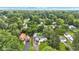 Aerial view of property showcasing landscaping, mature trees, and detached one-car garage at 6741 Evanston Ave, Indianapolis, IN 46220
