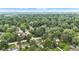 An aerial view that captures the serene setting of a neighborhood surrounded by mature trees and blue skies at 6741 Evanston Ave, Indianapolis, IN 46220