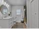 Bright bathroom featuring a modern vanity and a shower with stylish tile at 6741 Evanston Ave, Indianapolis, IN 46220