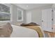 A comfortable bedroom with two windows features a bed and a soft throw blanket at 6741 Evanston Ave, Indianapolis, IN 46220