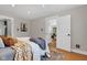 Sunlit bedroom featuring wood floors and a view into the living area at 6741 Evanston Ave, Indianapolis, IN 46220