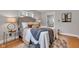 Comfortable bedroom featuring a gray headboard, stylish bedding, and a view to an adjacent bathroom at 6741 Evanston Ave, Indianapolis, IN 46220