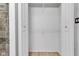 Open closet with white walls and shelves, located inside of the Primary bathroom at 6741 Evanston Ave, Indianapolis, IN 46220