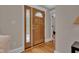 Welcoming entryway featuring a beautiful wood door with decorative glass and hardwood floors at 6741 Evanston Ave, Indianapolis, IN 46220