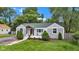 Charming single-story home with manicured lawn, front porch, and mature trees at 6741 Evanston Ave, Indianapolis, IN 46220