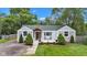 Charming single-story home with manicured lawn, front porch, and mature trees at 6741 Evanston Ave, Indianapolis, IN 46220
