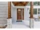 Elegant stained wood front door with stone support columns and decorative glass inserts at 6741 Evanston Ave, Indianapolis, IN 46220