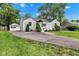 Charming home with a long driveway, well-maintained landscaping, and a detached garage at 6741 Evanston Ave, Indianapolis, IN 46220