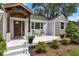Inviting front porch with stylish seating, a beautifully stained wood door, and stone accents at 6741 Evanston Ave, Indianapolis, IN 46220