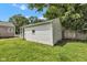 Side view of detached one-car garage with white siding and green lawn at 6741 Evanston Ave, Indianapolis, IN 46220