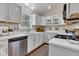 Modern kitchen with white cabinets, stainless steel appliances, and quartz countertops at 6741 Evanston Ave, Indianapolis, IN 46220